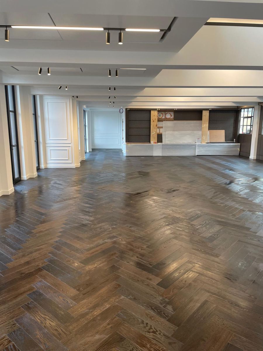 Herringbone floor laid across an open-plan London reception room