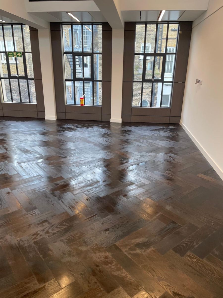 Polished wood flooring finish running through a period room