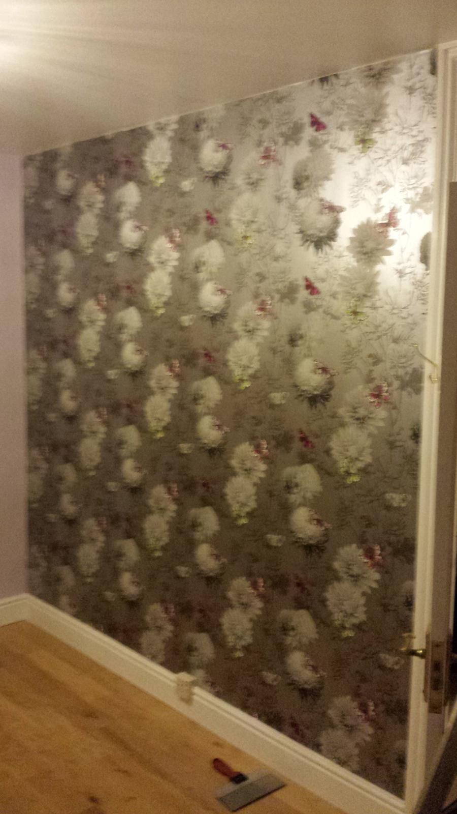 Wallpaper installation with pattern matched across the drop