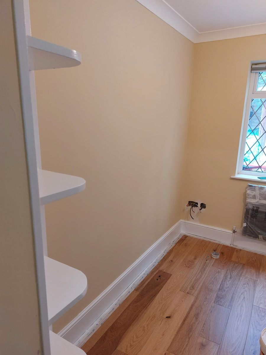 Decorated room with fitted shelving and finish carpentry